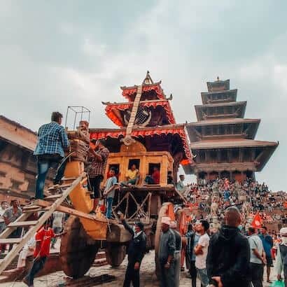 a group of people standing on a wooden carriage