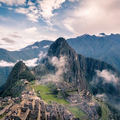 a mountain with buildings and fog