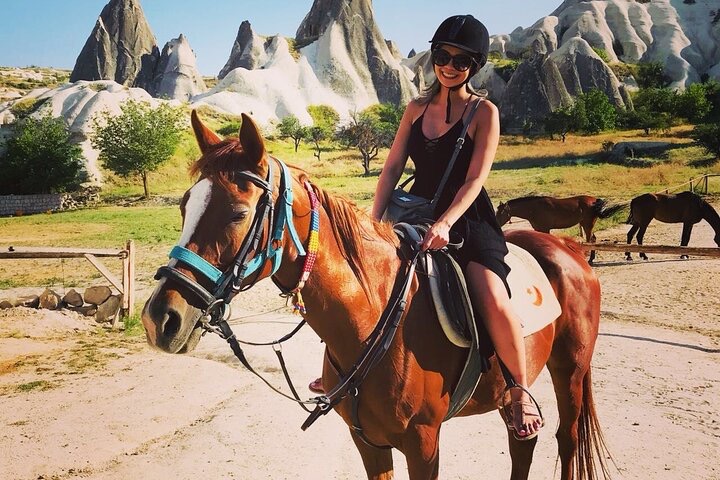 a woman riding a horse