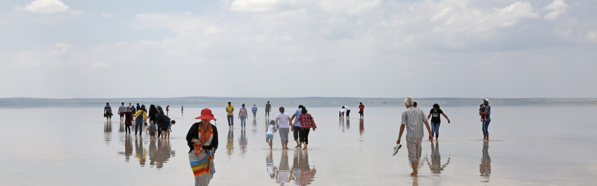 a group of people walking on a beach