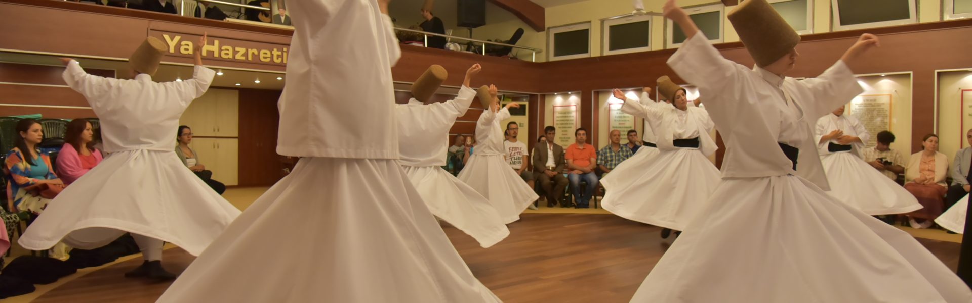 a group of people wearing white robes and dancing