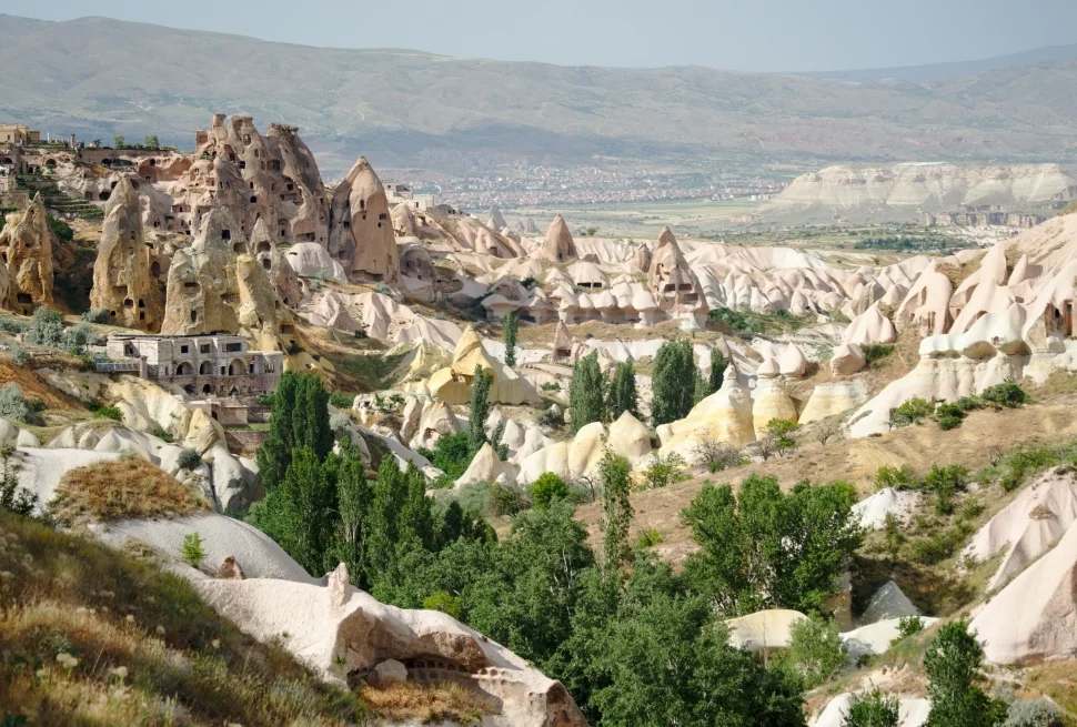 a landscape with a rocky hill and buildings