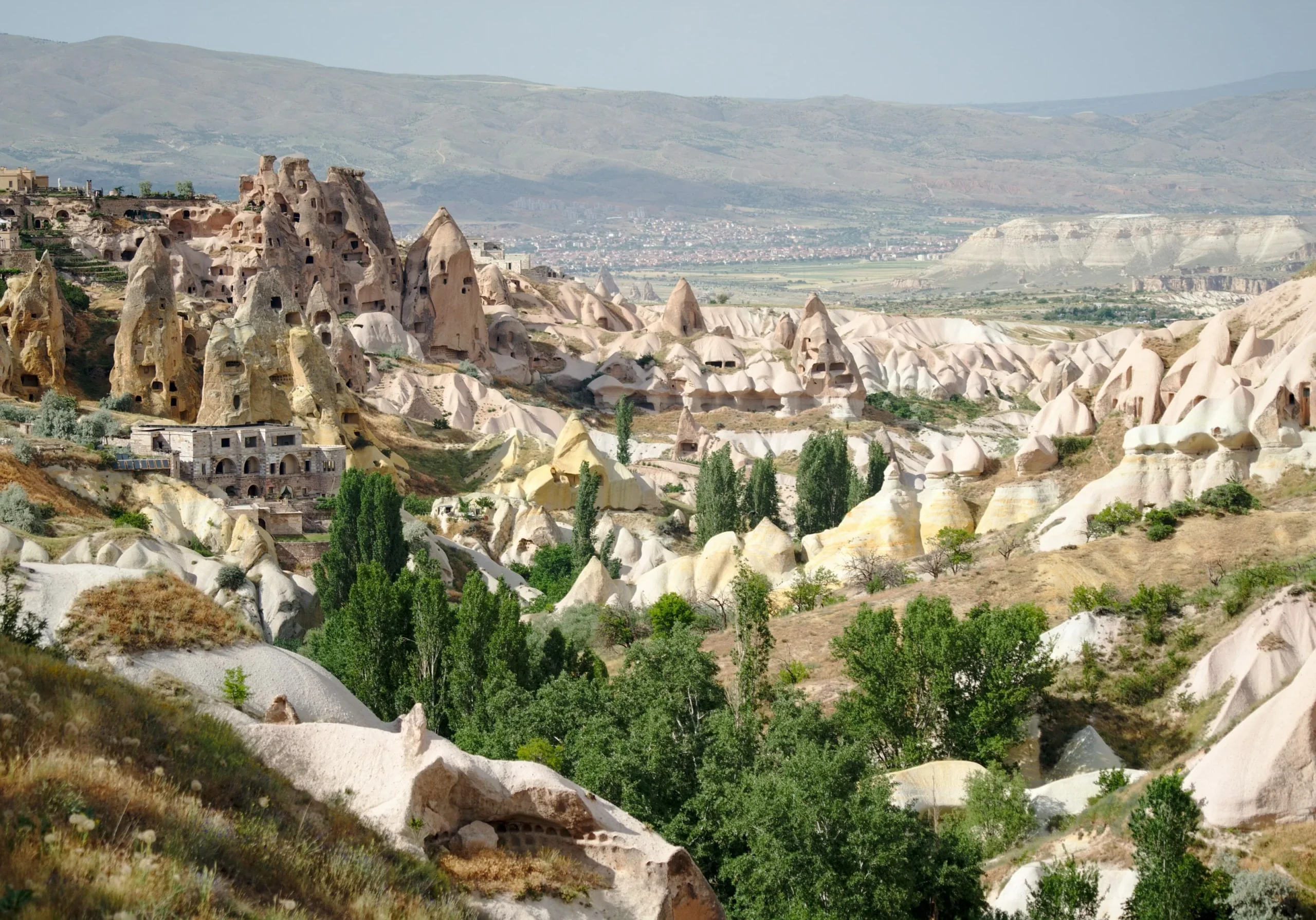 a landscape with a rocky hill and buildings